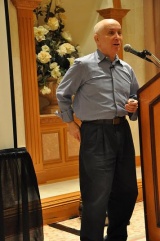 Michael Horn giving a seminar on 29th May 2011. Meier is pictured on the screen behind him, departing for a contact on his motorbike.[159]