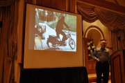 Michael Horn giving a seminar on 29th May 2011. Meier is pictured on the screen behind him, departing for a contact on his motorbike.[157]