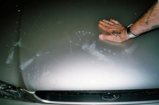 Billy's hand next to fingerprints of a 7 fingered ET.